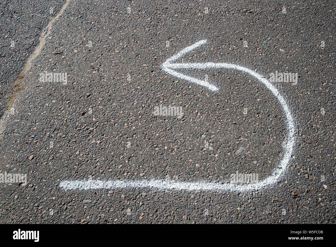 return arrow painted on tarmac Stock Photo