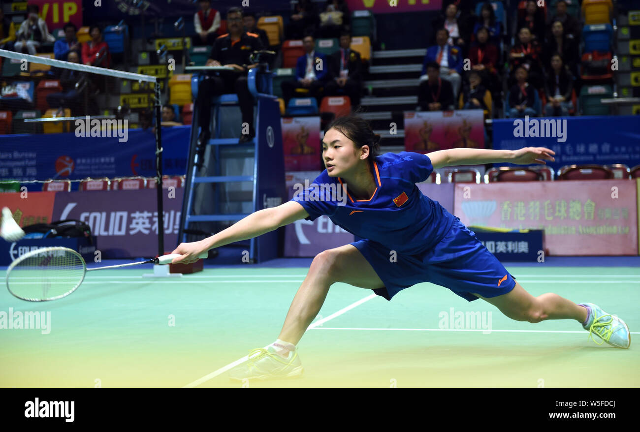 Han Yue of China returns a shot to Sayaka Takahashi of Japan during the