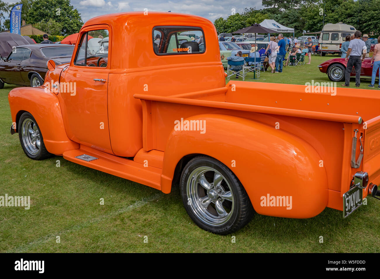 Classic Chevrolet pickup truck in bright orange on display at the annual classic car show in Wroxham, Norfolk, UK Stock Photo
