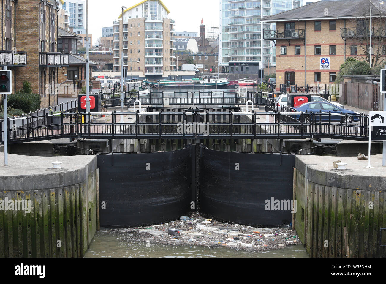 Rubbish piles up at the lock gates of Limehouse Marina in East London. Stock Photo