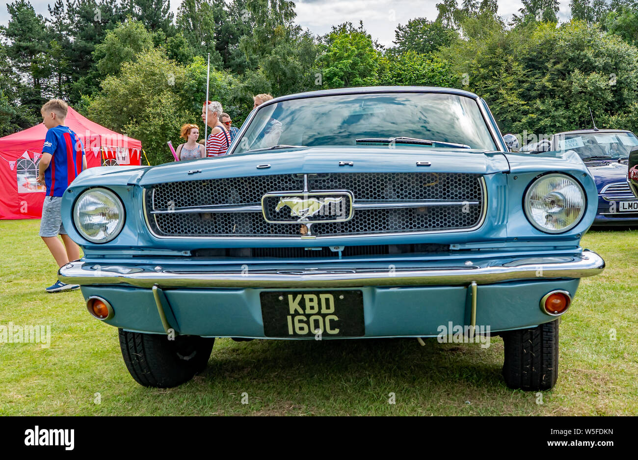 Front view of a blue vintage Ford Mustang on display at the annual classic car show in Wroxham, Norfolk, UK Stock Photo