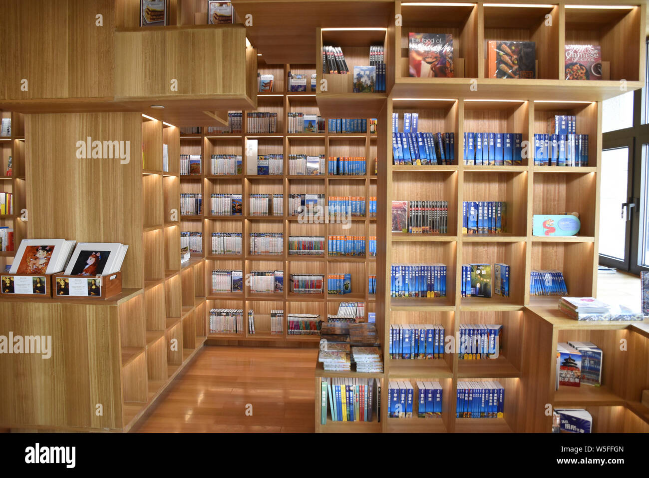 Customers read books in a branch of Page One bookstore at the Qianmen