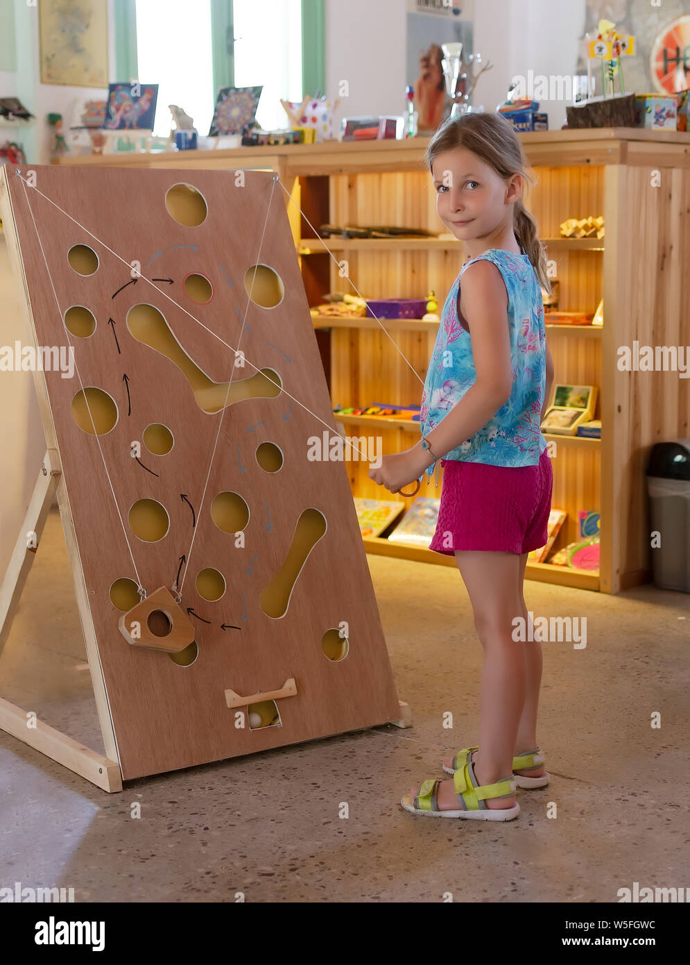 Little girl playing a wooden maze game Mouse in the cheese Stock Photo -  Alamy