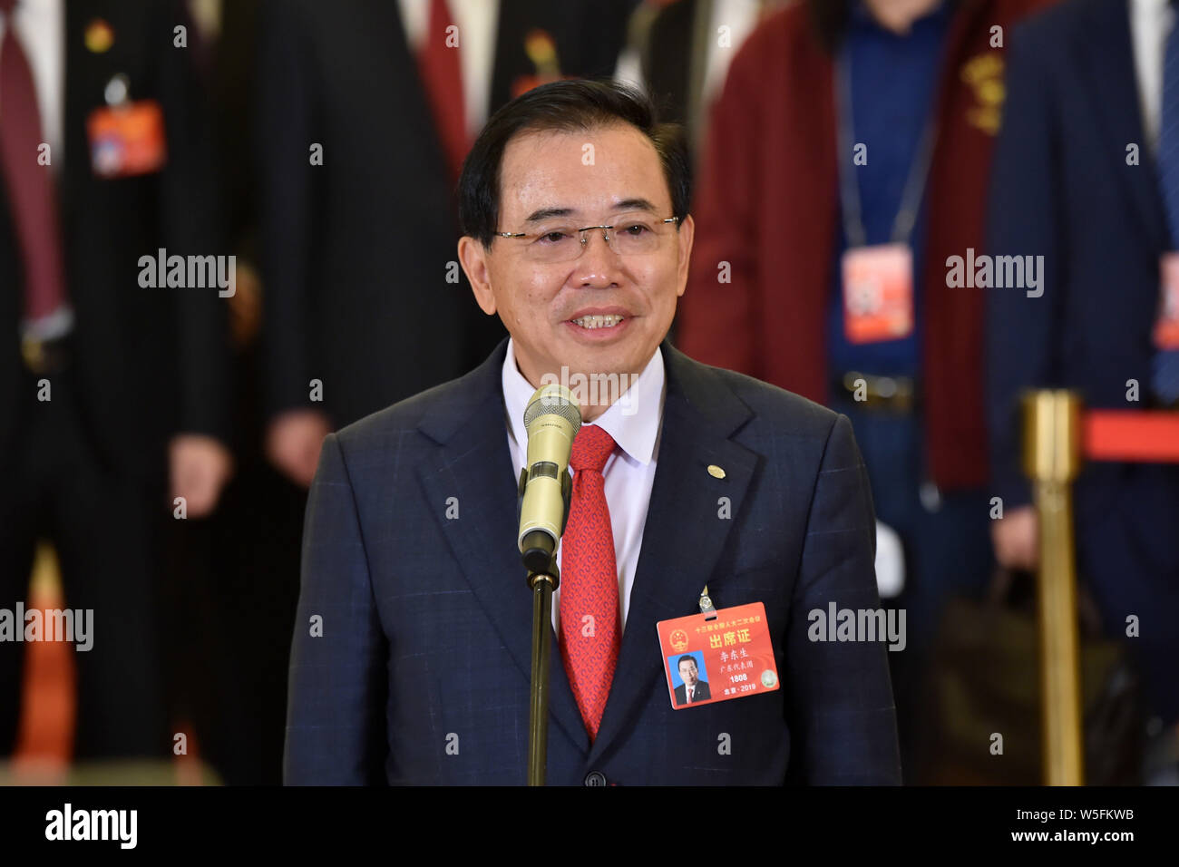 Li Dongsheng, Chief Executive Officer of TCL,  is interviewed as he arrives at the 'delegate passage' for the second session of the 13th National Peop Stock Photo