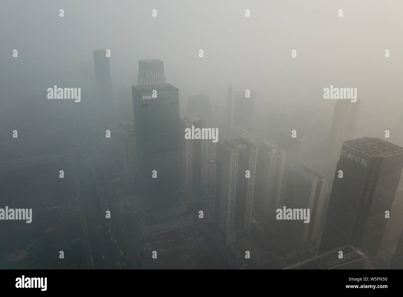 Buildings are shrouded by heavy fog in Hefei city, east China's Anhui province, 6 March 2019. Stock Photo