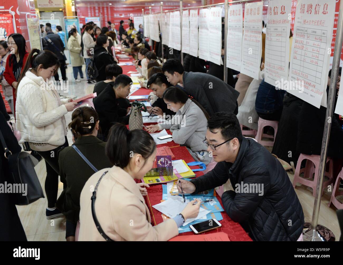 Chinese job seekers look for employment at a job fair in Tengzhou city, Zaozhuang city, east China's Shandong province, 9 March 2019.   Despite a gloo Stock Photo
