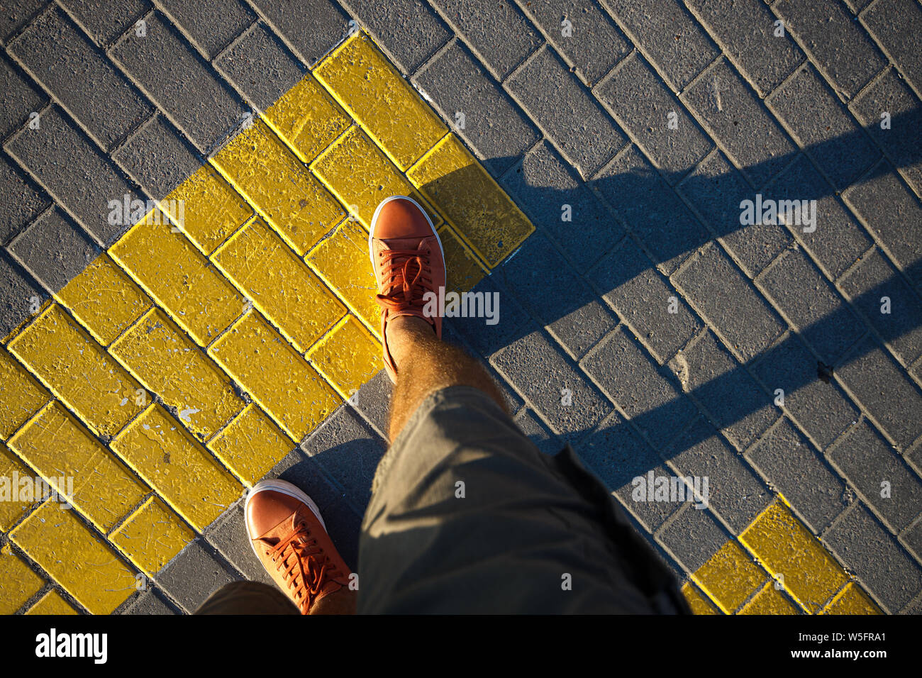 First person view man in red sneakers. Stock Photo
