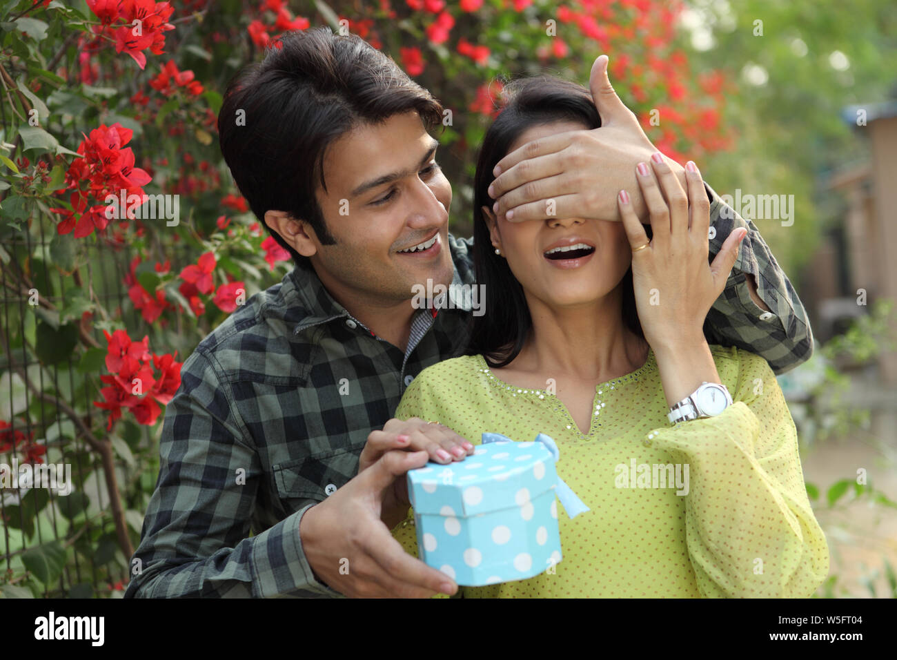 Man giving a gift to his wife Stock Photo Alamy