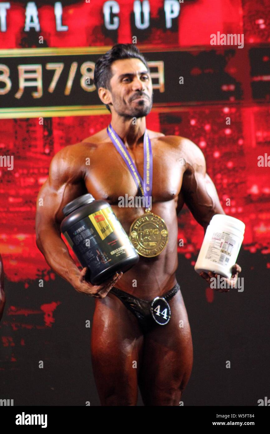 An Iranian Bodybuilder Poses After Winning During The Tera Cup Images, Photos, Reviews