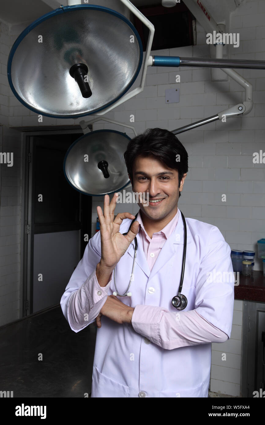 Male doctor showing ok sign and smiling Stock Photo