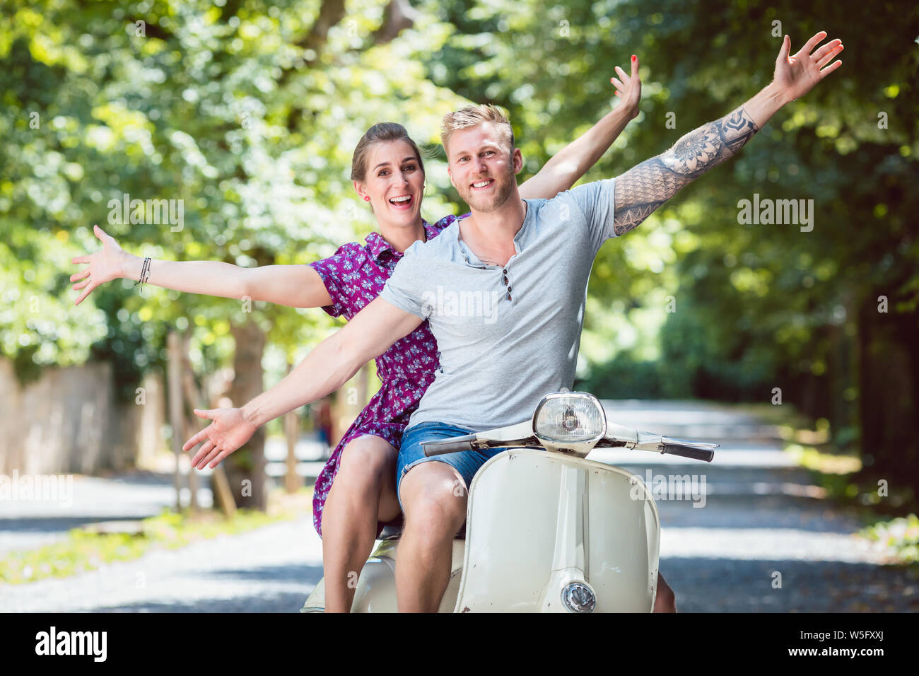 Young couple on retro scooter Stock Photo