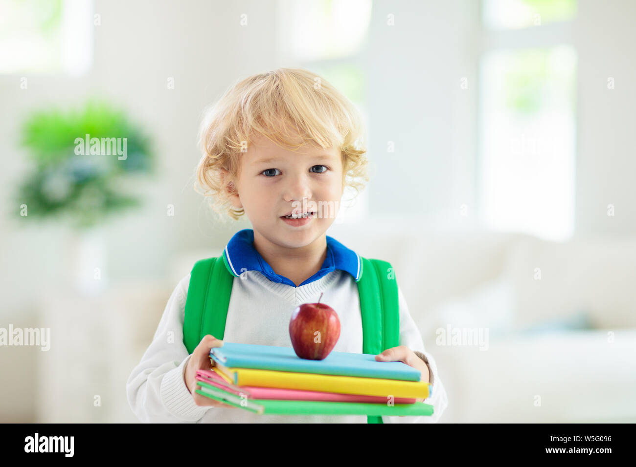 Child going back to school. Kid getting ready for first school day after vacation. Little boy on his way to kindergarten or preschool. Student packing Stock Photo