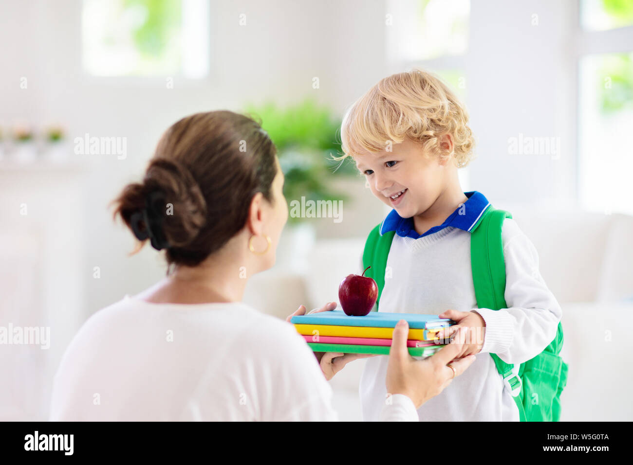 Child going back to school. Mother and kid getting ready for first