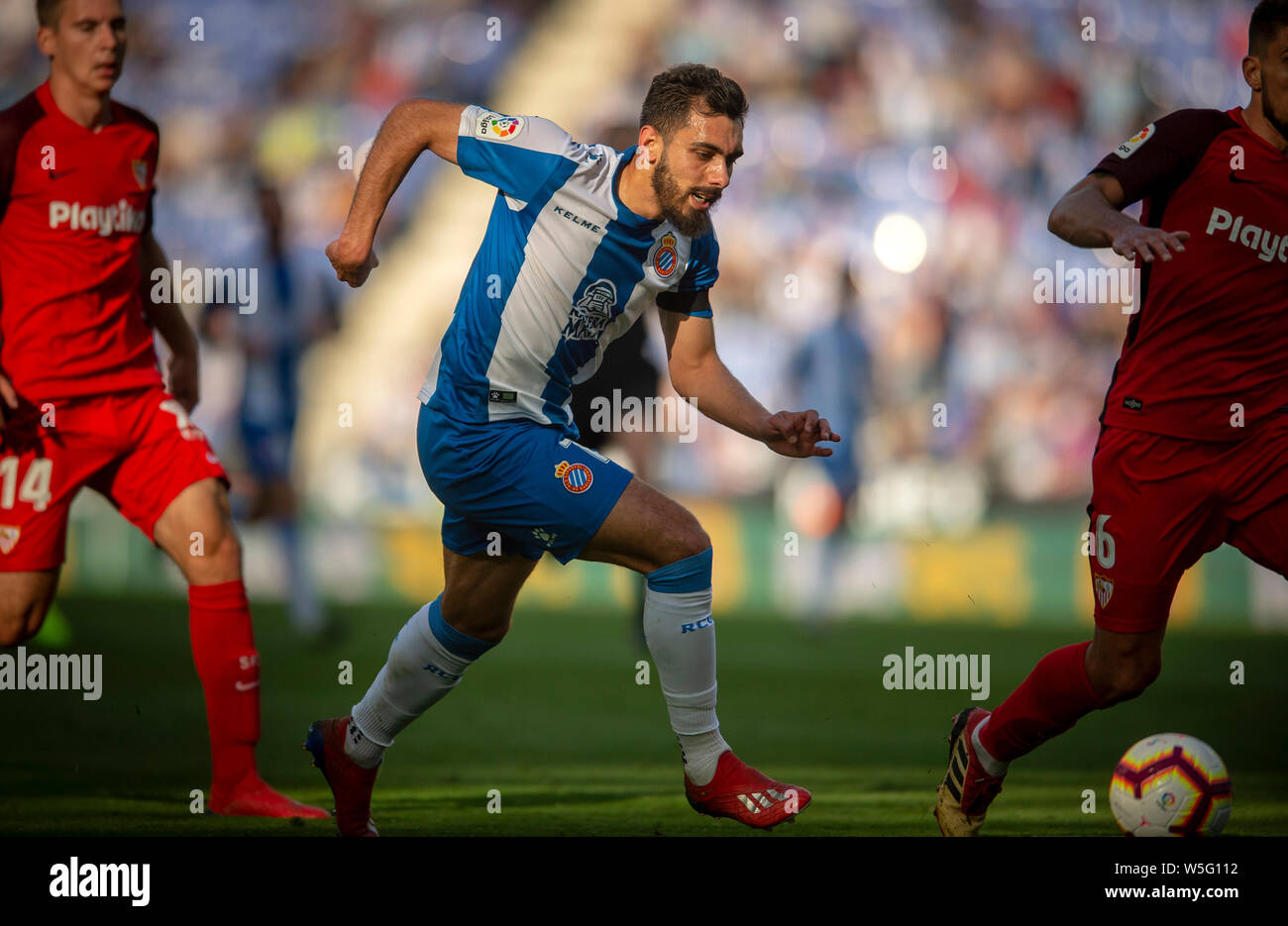 Borja Iglesias of RCD Espanyol, center, challenges Maximilian Wober, left,  and Daniel Carrico of Sevilla FC during their 28th round match of the La Li  Stock Photo - Alamy