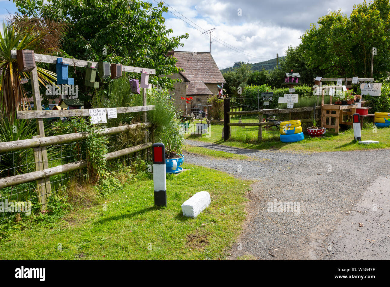 Entrance to a rural house, near Ludlow, Shropshire, UK, selling home made birdboxes and plants, with an honesty box. Stock Photo