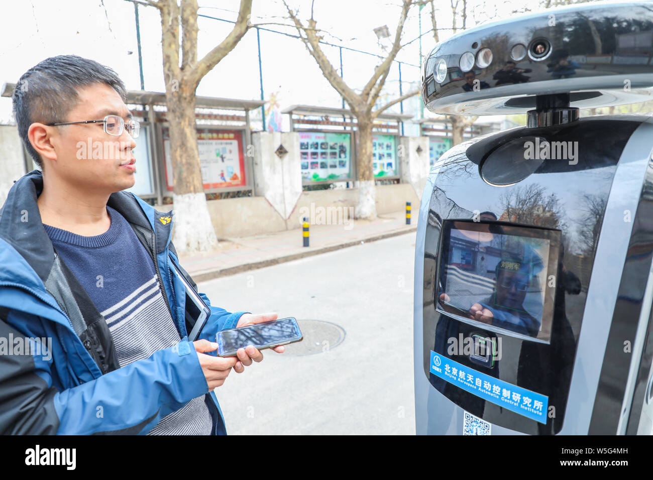 A technician has his face scanned by a face recognition system to test the early warning identification of strangers through the smart robot 'Meibao' Stock Photo