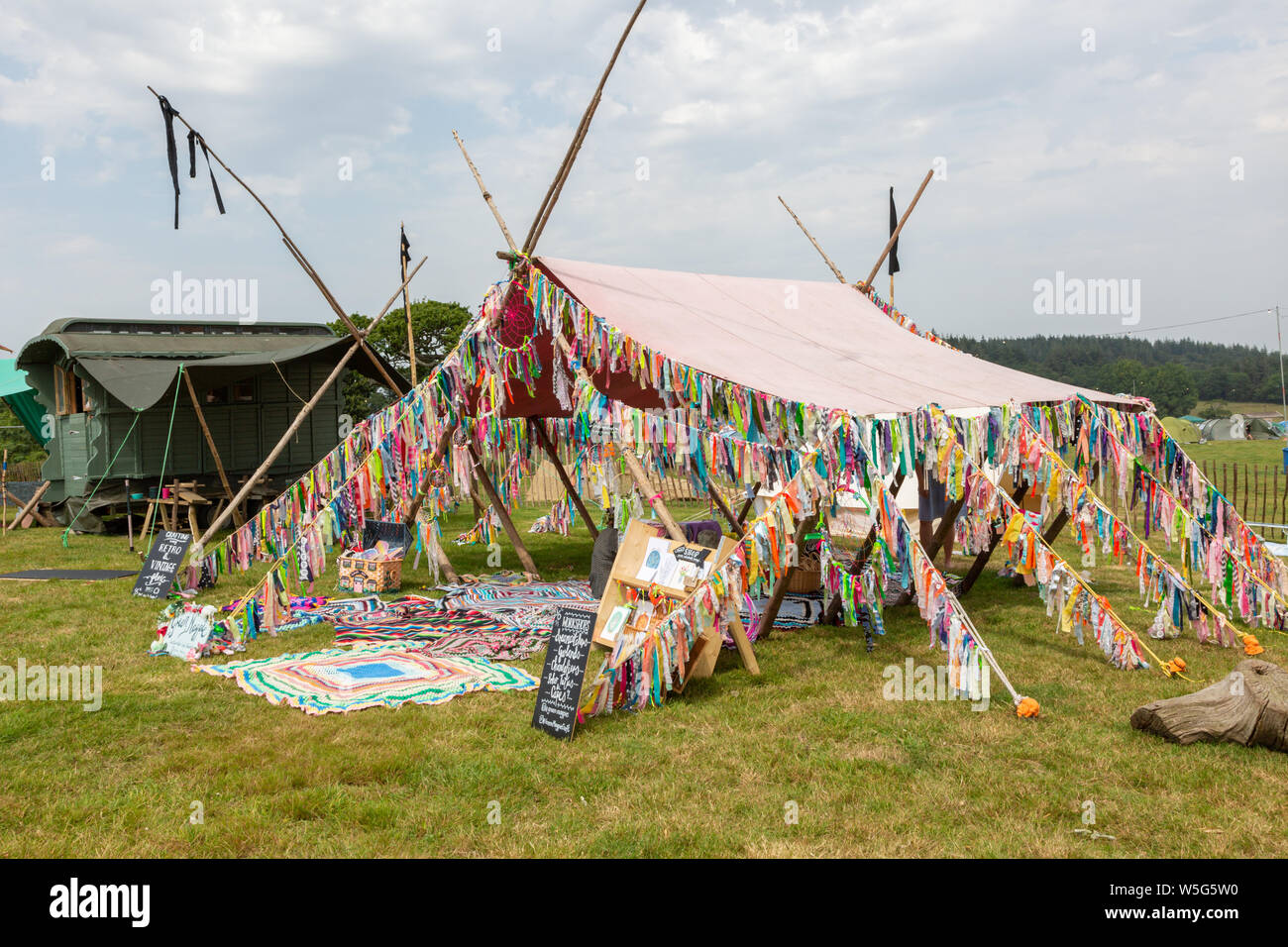 A tent adorned with colourful rags at a festival, UK Stock Photo