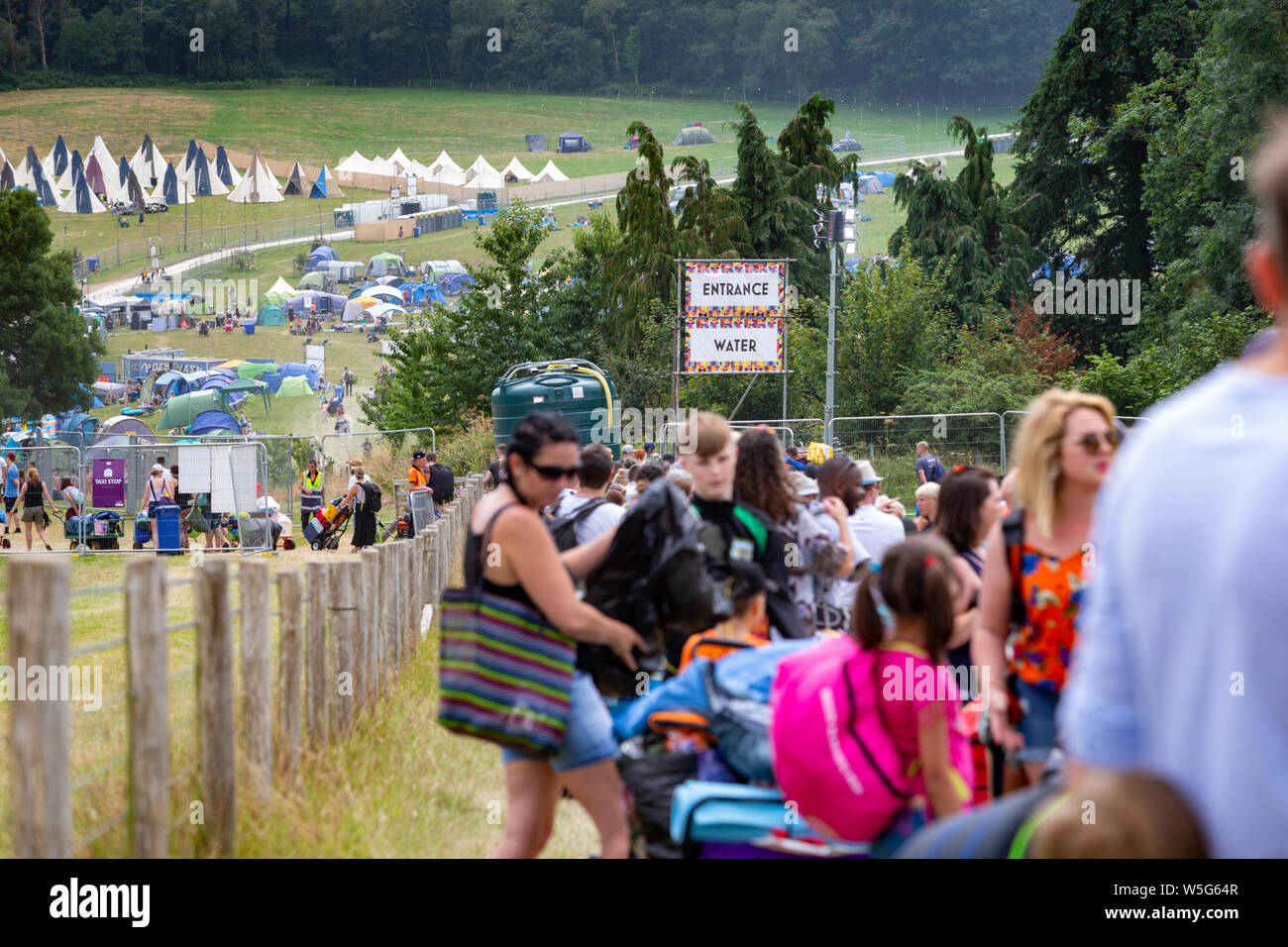 People arriving and queuing on the first day of Camp Bestival, Lulworth Castle grounds, Dorset, UK Stock Photo