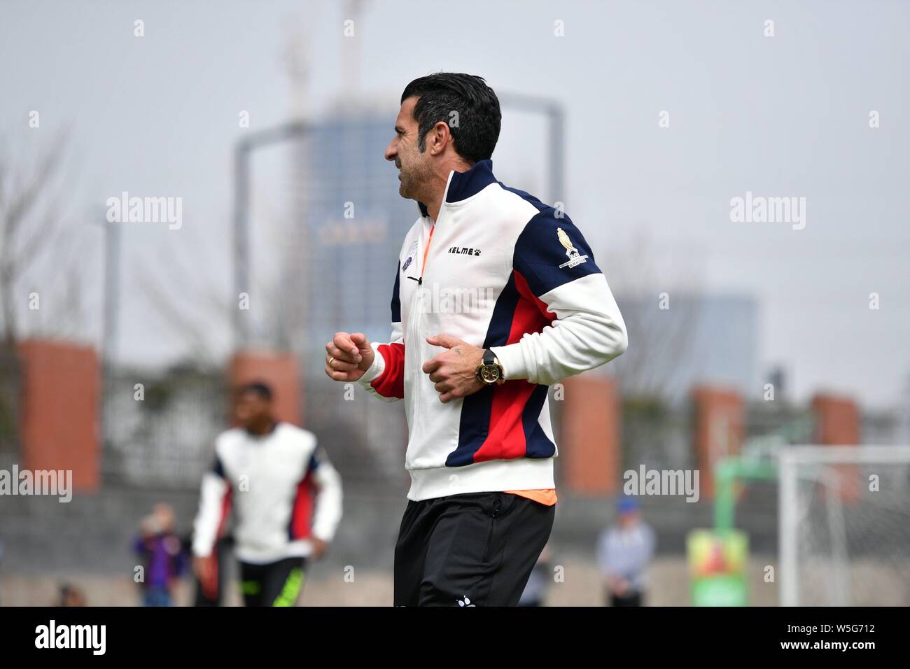 Portuguese former football player Luis Figo plays football with students at an event for the IFDA world legends series - Football Legends Cup - China Stock Photo