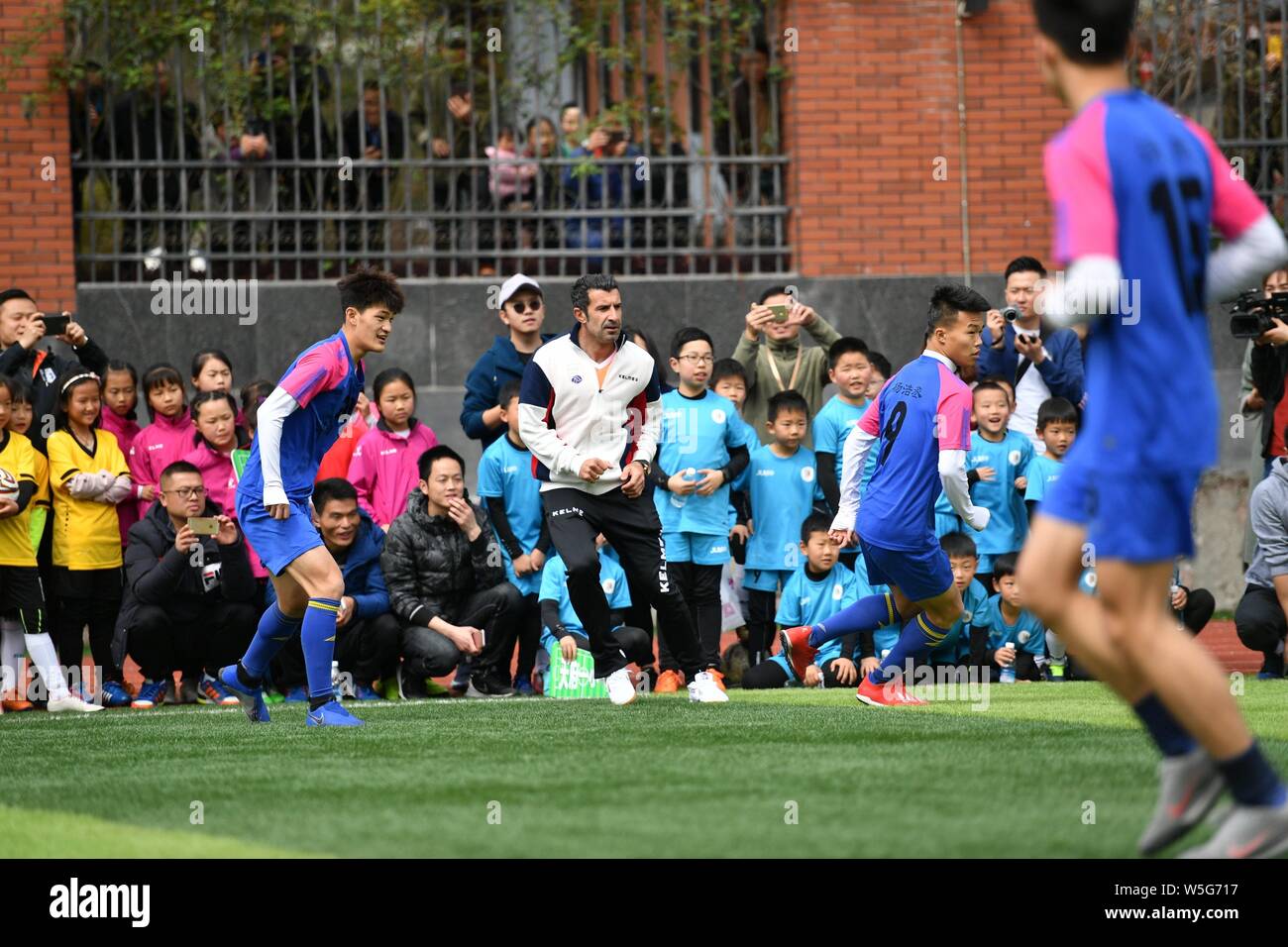 Portuguese former football player Luis Figo plays football with students at an event for the IFDA world legends series - Football Legends Cup - China Stock Photo