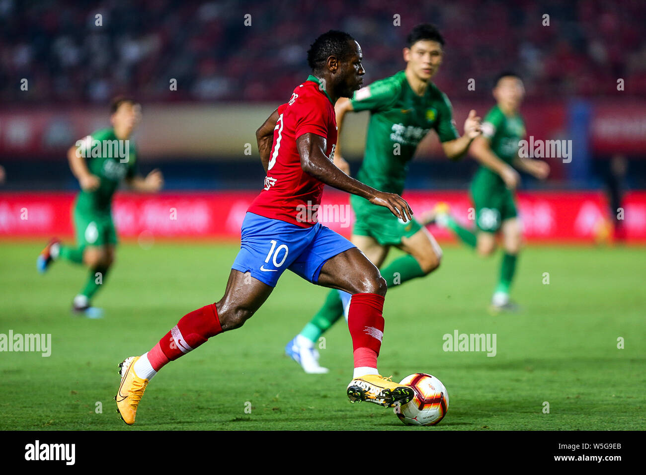 Cameroonian football player Christian Bassogog, of Henan Jianye dribbles against Beijing Sinobo Guoan in their 20th round match during the 2019 Chinese Football Association Super League (CSL) in Zhengzhou city, central China's Henan province, 27 July 2019. Henan Jianye defeated Beijing Sinobo Guoan 1-0. Stock Photo
