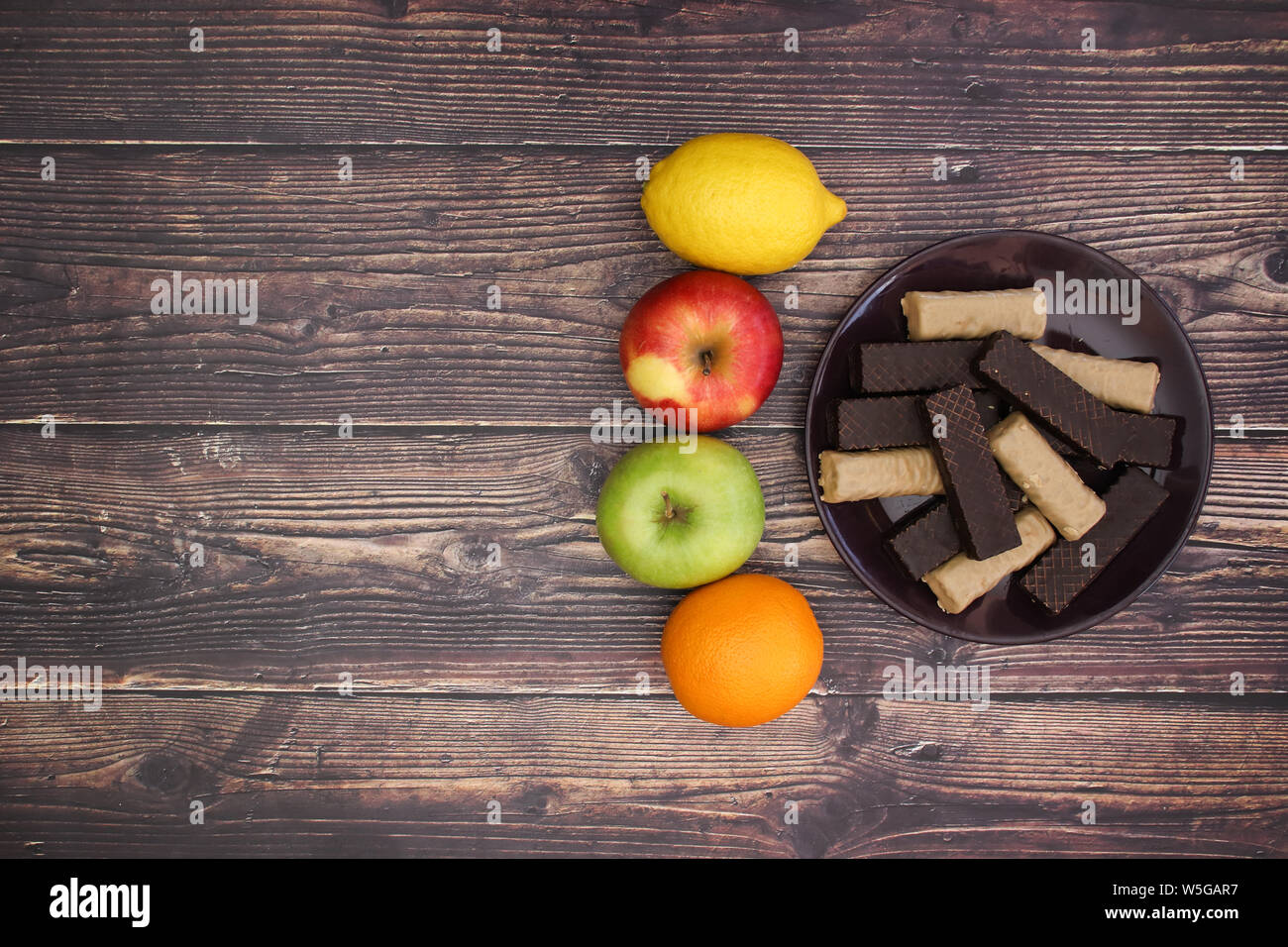 Fruits and healthy lifestyle vs cookies Stock Photo Alamy