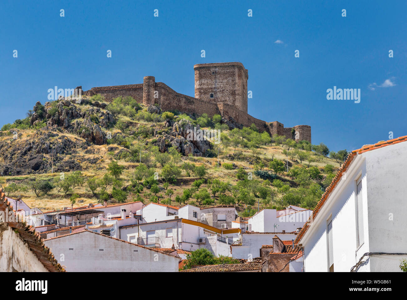 Hilltop castle over white town of Feria, Tierra de Barros region, Badajoz province, Extremadura, Spain Stock Photo