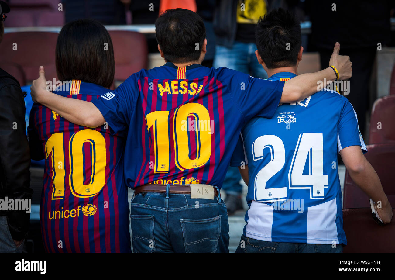 Football fans wearing team jerseys of Wu Lei and Lionel Messi to show their  support pose for pictures during the 29th round match of the La Liga 2018  Stock Photo - Alamy