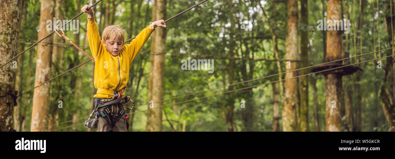Little boy in a rope park. Active physical recreation of the child in