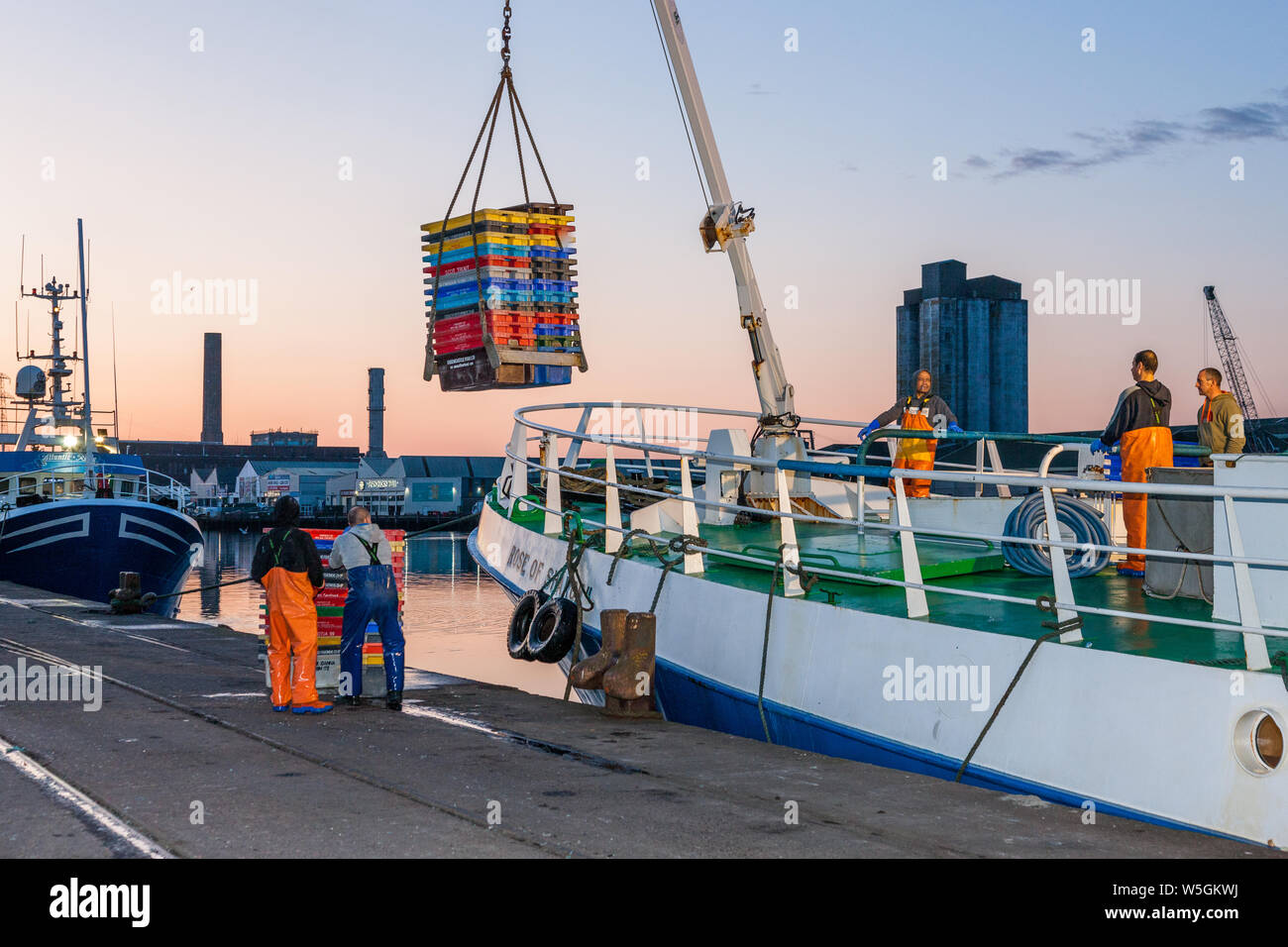 Cork City, Cork, Ireland. 29th July, 2019. Crew of the trawler Rose of Sharon load empty fish boxes on to the deck as they prepare their boat to depart for the fishing grounds on Horgan's Quay in Cork City, Ireland. Credit;  David Creedon / Alamy Live News Stock Photo