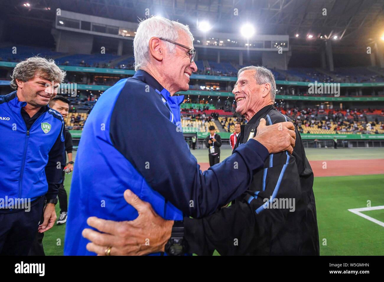 Head coach Hector Cuper of Uzbekistan, left, and head coach Oscar Tabarez of Uruguay greet each other before their semi-final match of the 2019 China Stock Photo