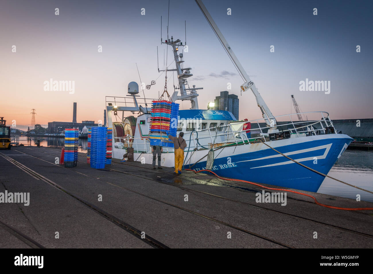 Cork City, Cork, Ireland. 29th July, 2019. Crew of the trawler Atlantic Rose load empty fish boxes on to the deck as they prepare their boat to depart for the fishing grounds on Horgan's Quay in Cork City, Ireland. Credit;  David Creedon / Alamy Live News Stock Photo