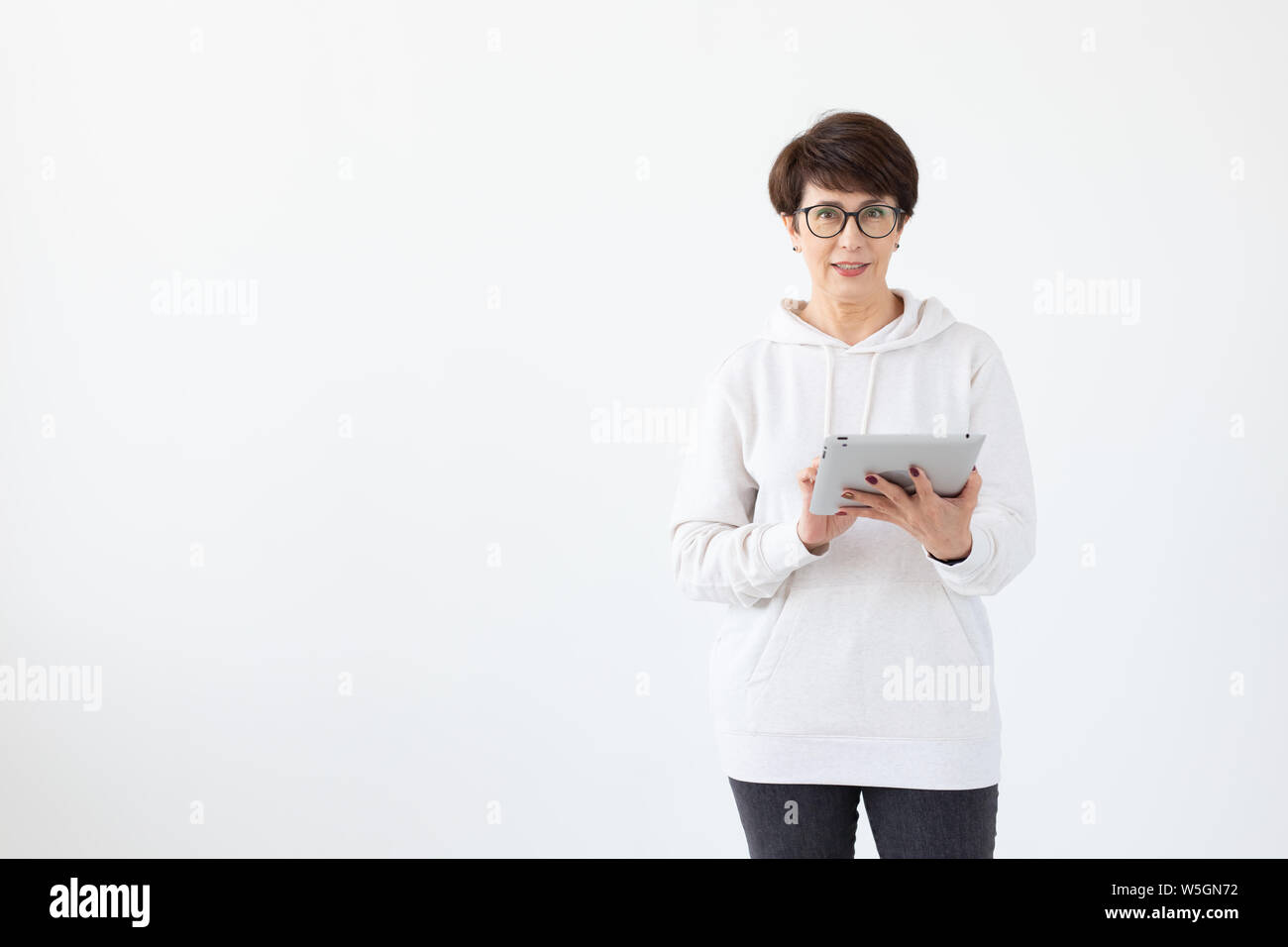 Beautiful Woman 50 Years Old With Short Hair Holding Tablet On