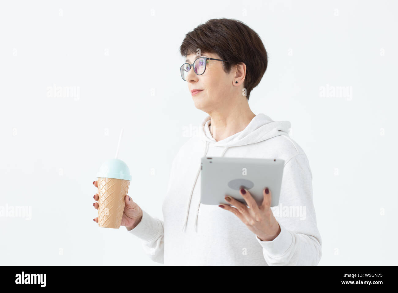Beautiful Woman 50 Years Old With Short Hair Holding Tablet And