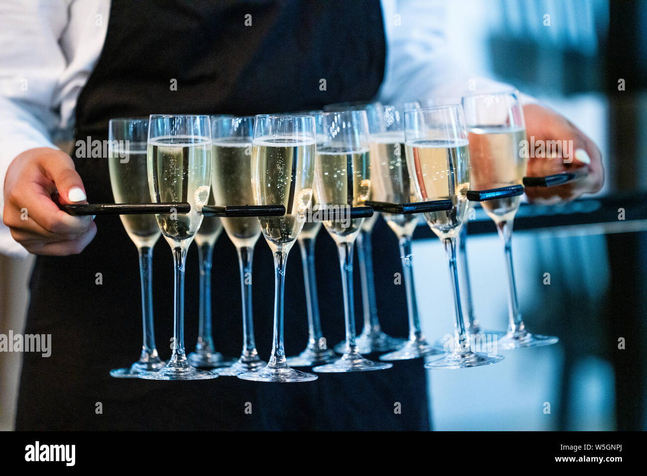 Close Up Of Waitress Serving Glasses Of Champagne At Event Stock Photo