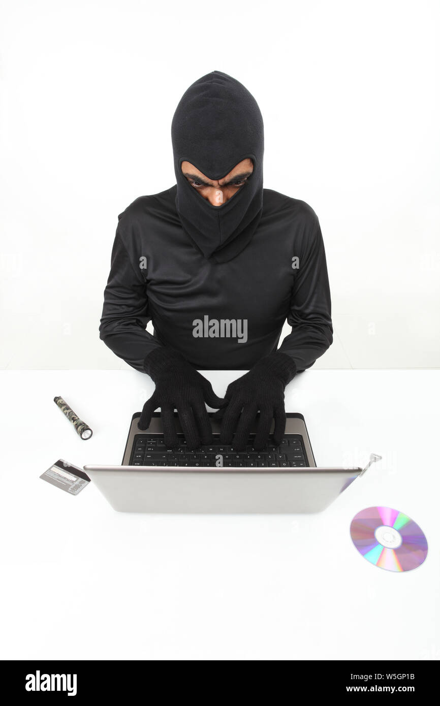 Hacker stealing information from laptop Stock Photo