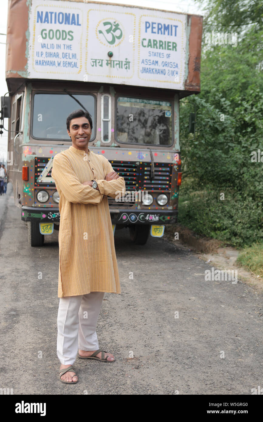 Truck driver standing with his arms crossed Stock Photo Alamy