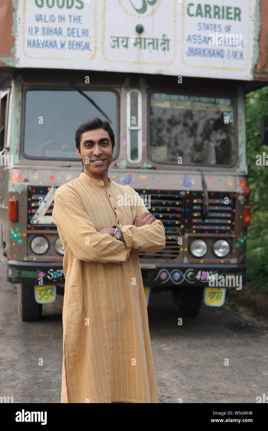 Truck driver standing with his arms crossed Stock Photo Alamy