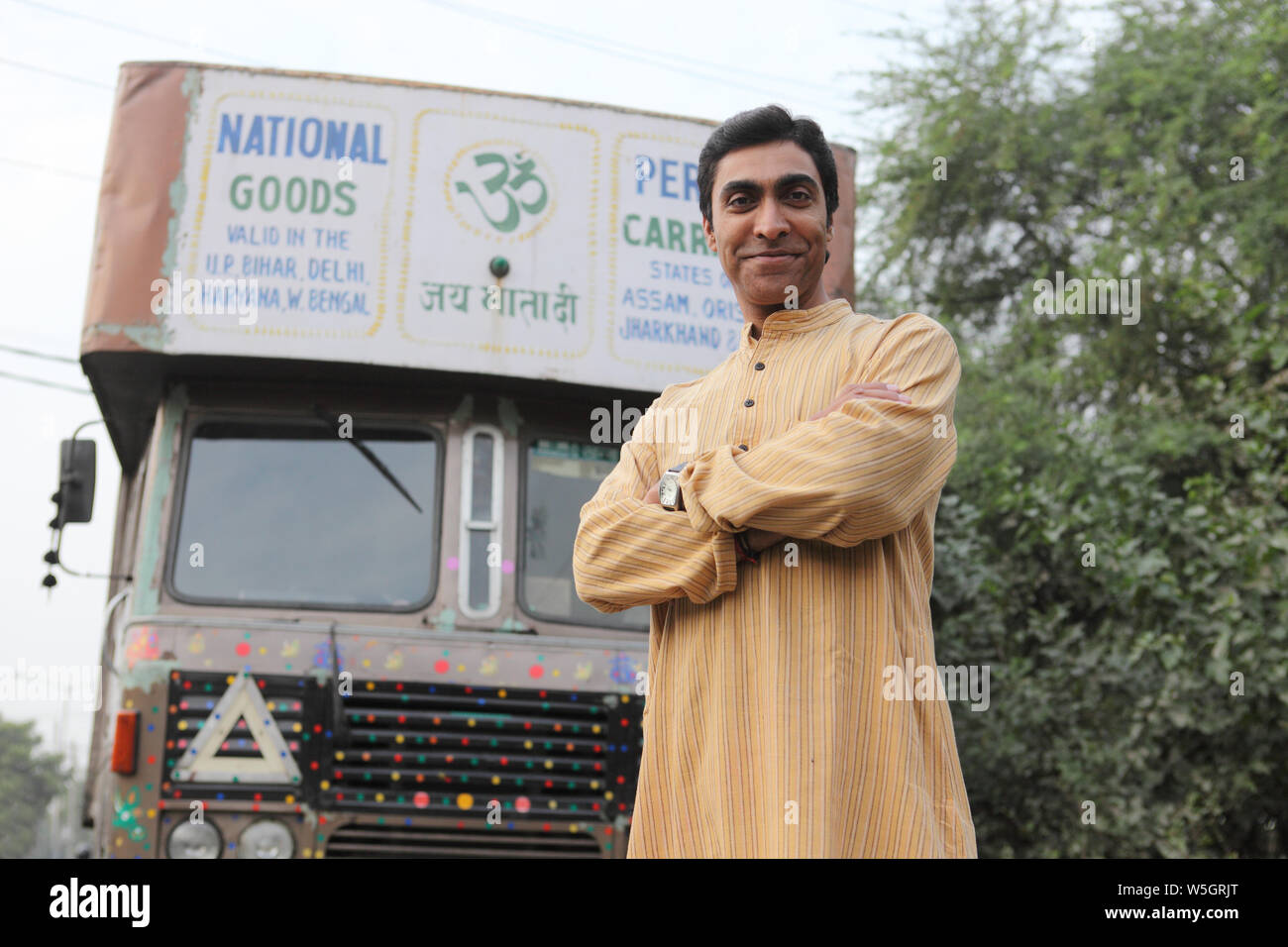 Truck driver standing with his arms crossed Stock Photo Alamy