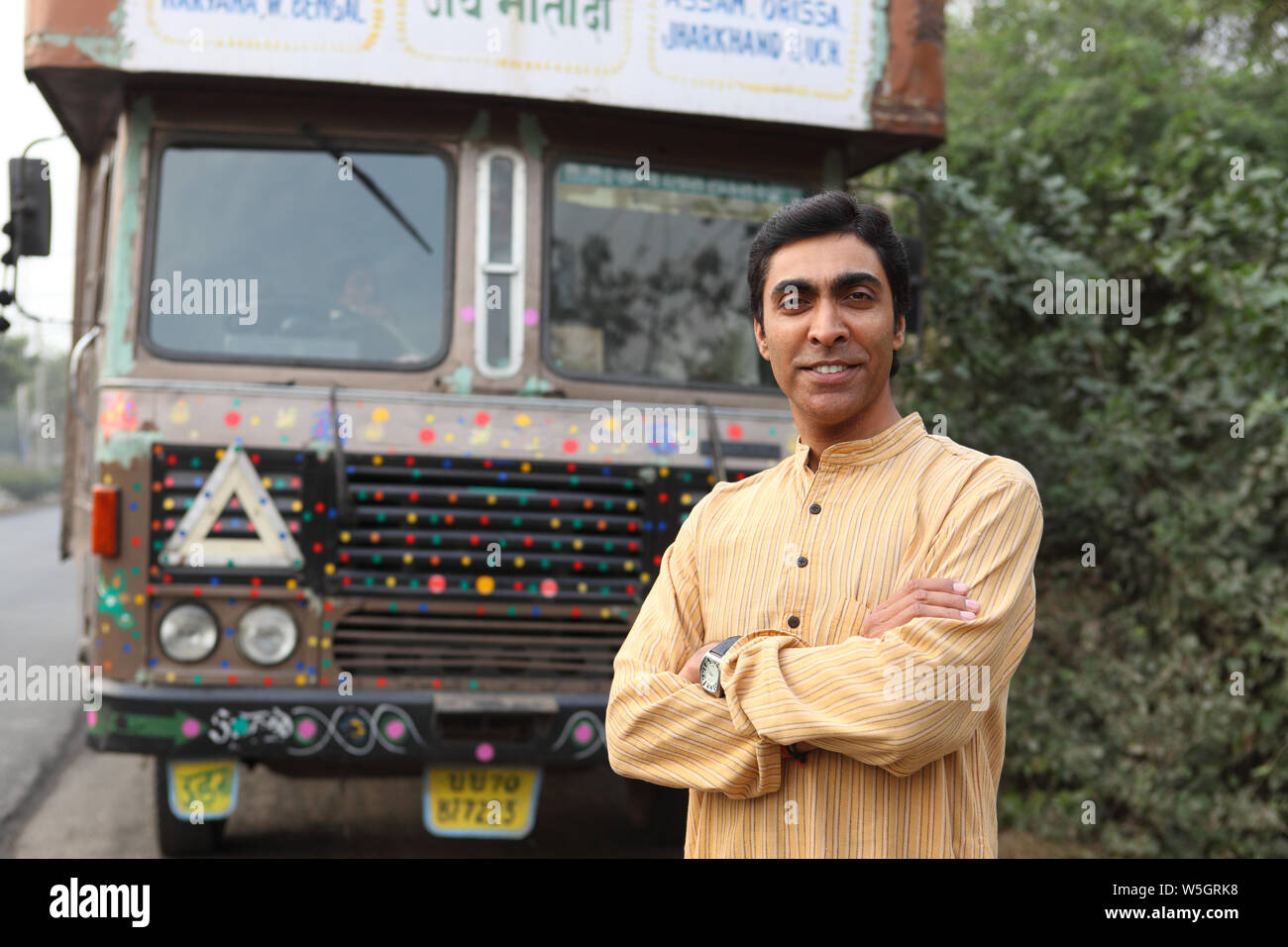 Truck driver smiling with his arms crossed Stock Photo Alamy
