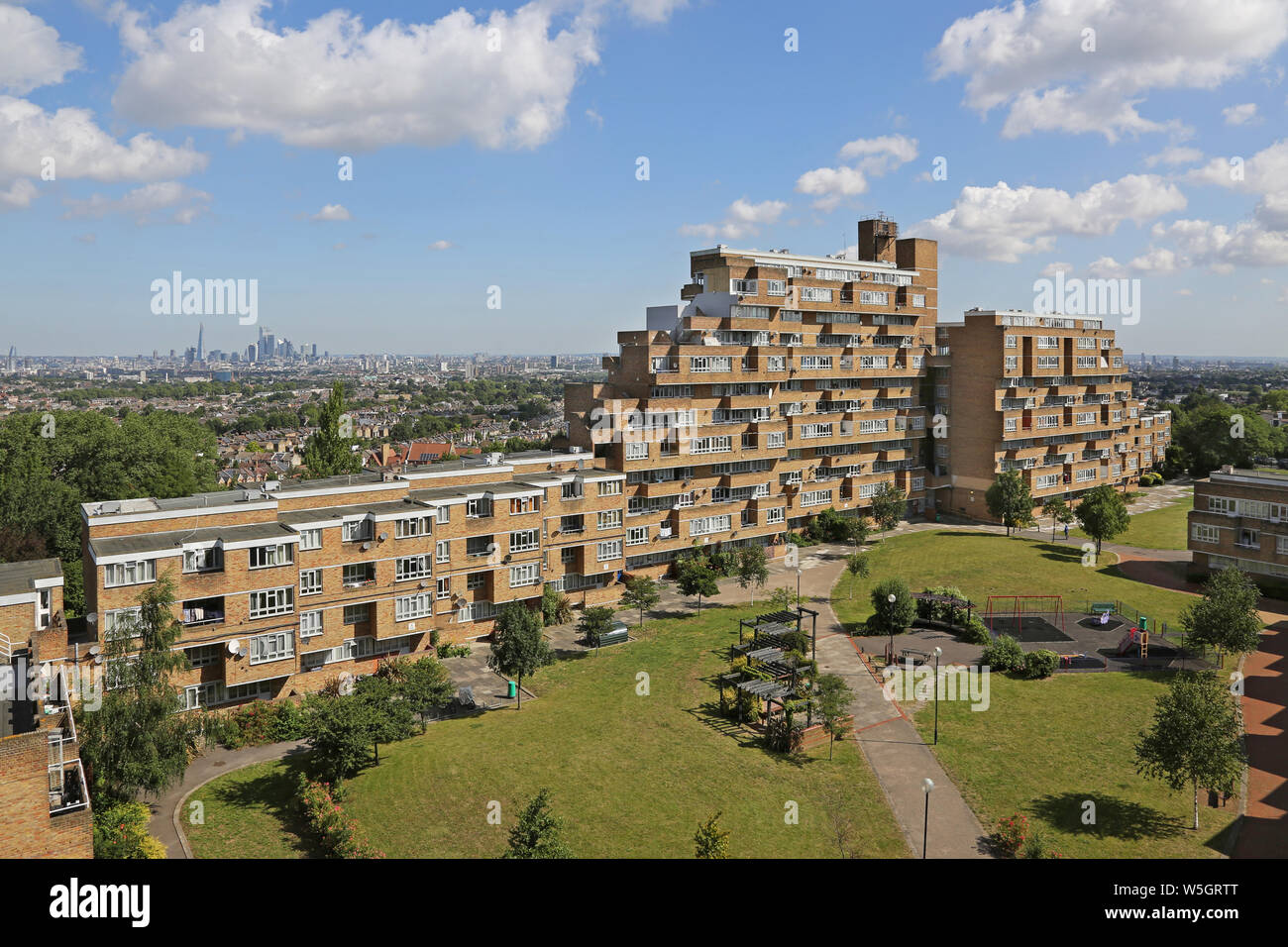 High level view of Dawson's Heights, the famous 1960s public housing project in South London, designed by Kate Macintosh. London skyline beyond. Stock Photo