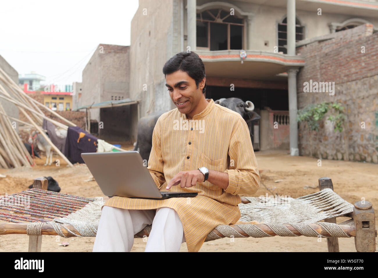 Farmer using a laptop Stock Photo - Alamy