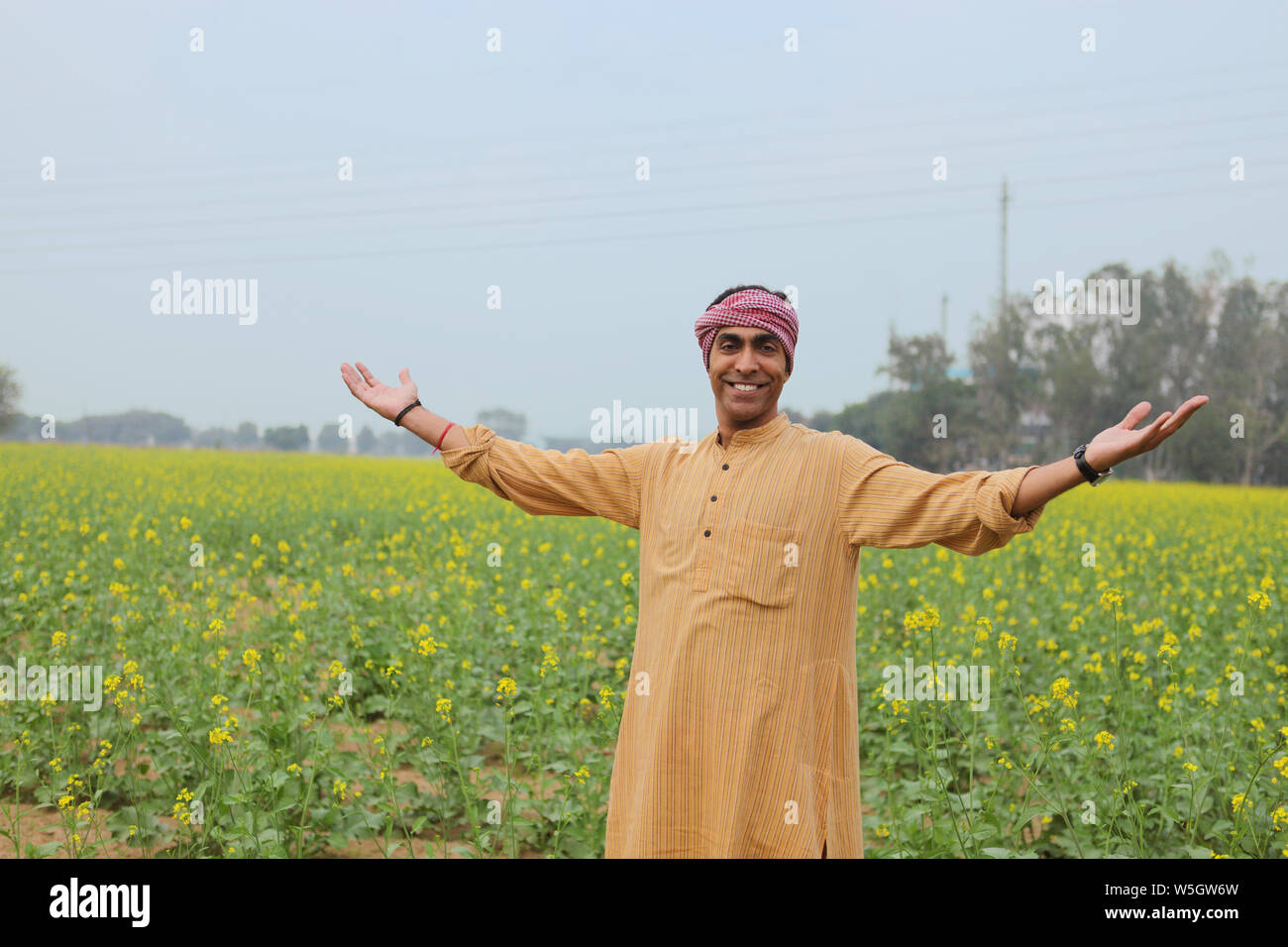 Farmer showing his mustard crop Stock Photo - Alamy