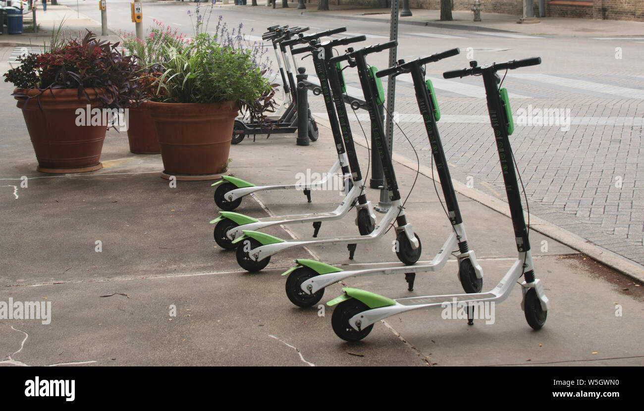 Dockless Electric Scooters on the Sidewalk Stock Photo