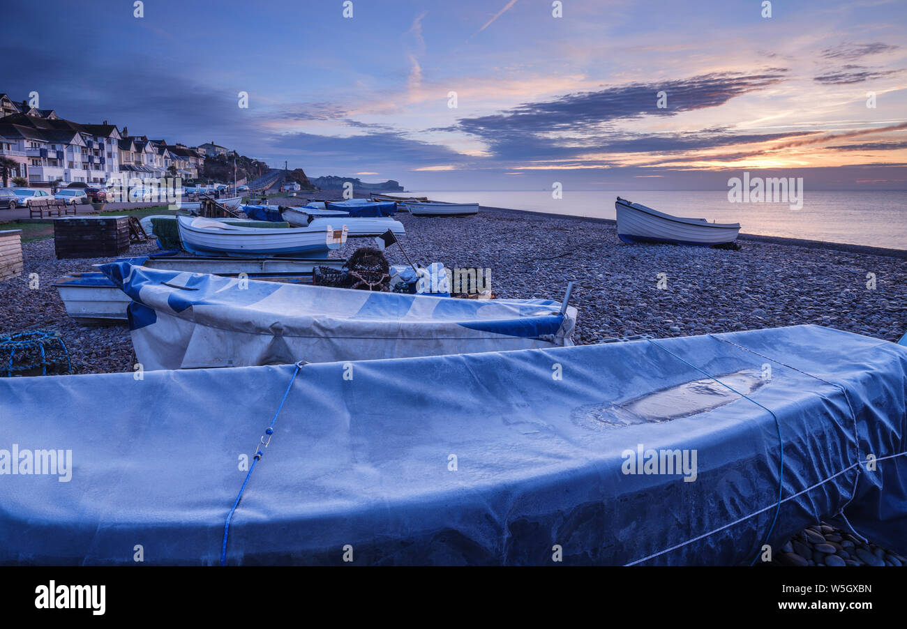 Serene dawn scene of fishing boats on the pebbled beach at Budleigh Salterton, Devon, England, United Kingdom, Europe Stock Photo