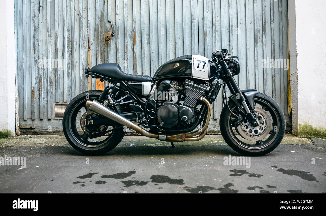 Customized motorcycle in front of garage door Stock Photo