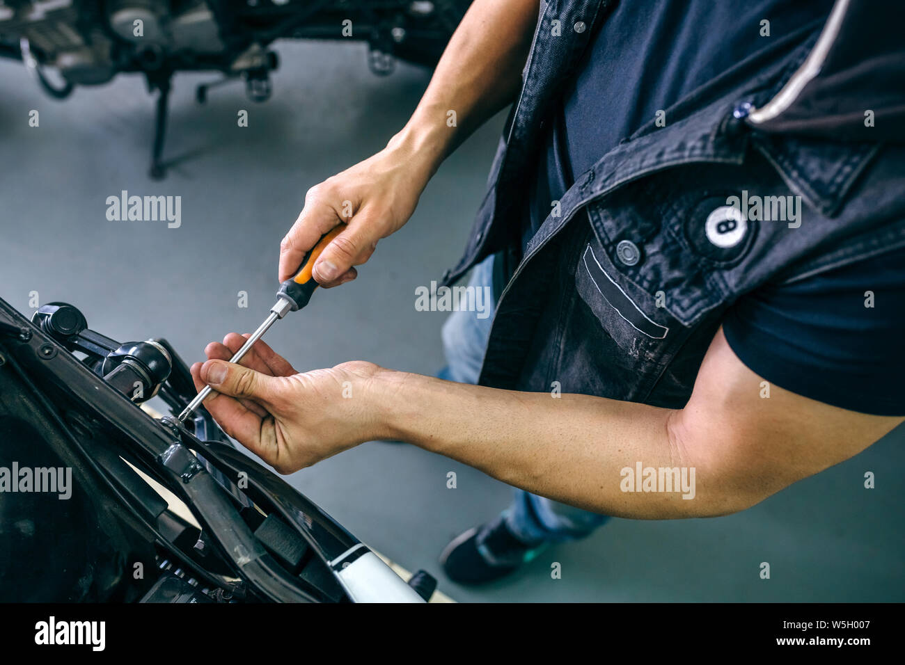 Mechanic repairing customized motorcycle Stock Photo