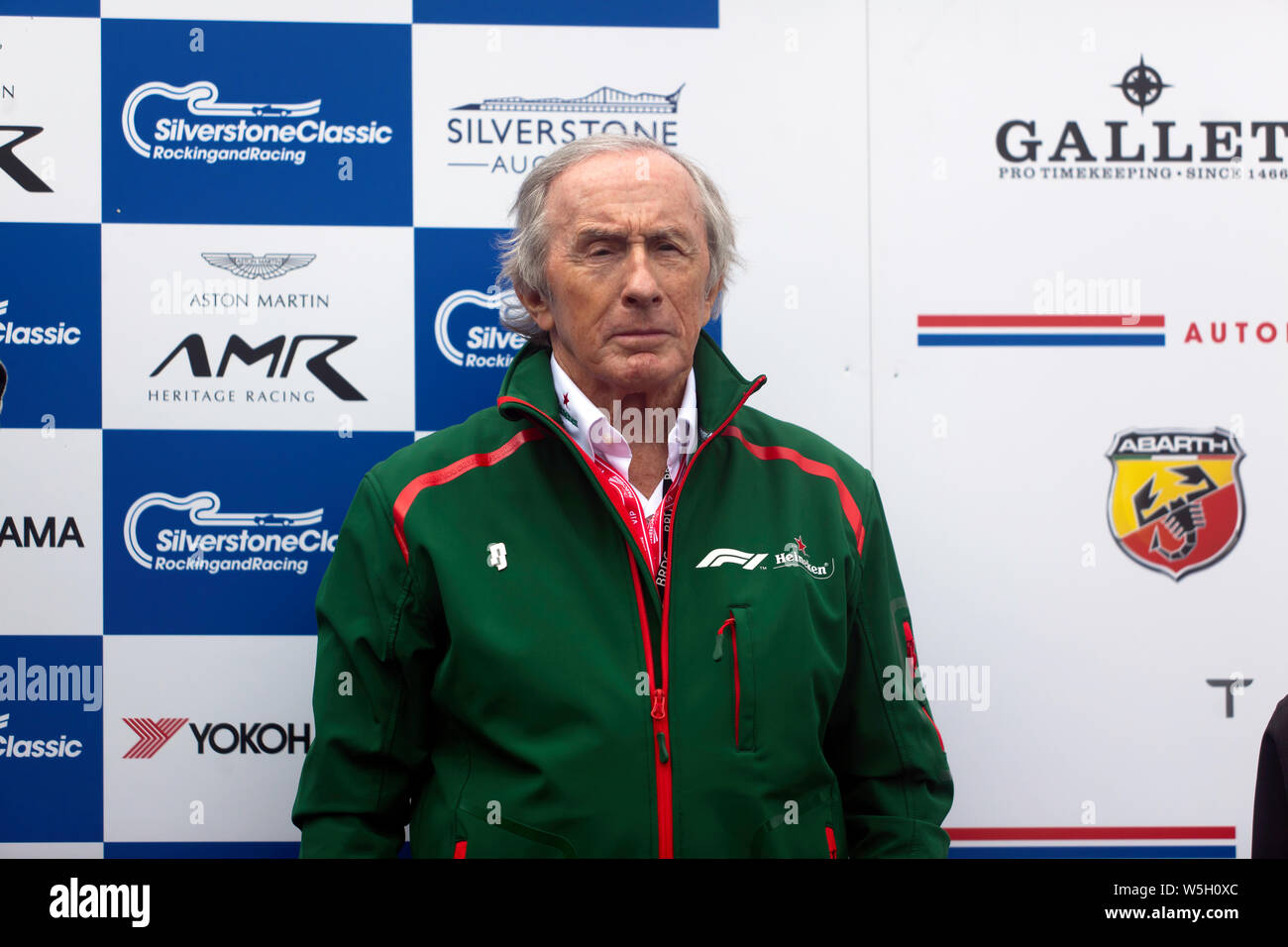Sir Jackie Stewart respecting the national anthem, at the  winners ceremony for  the FIA Masters Historic Formula One race. Stock Photo