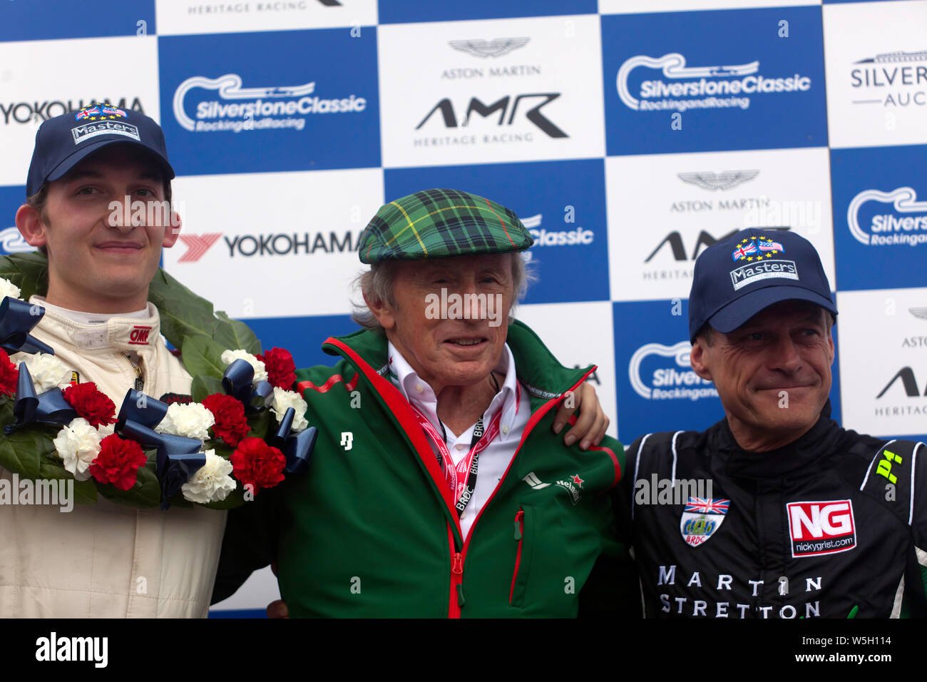 Sir Jackie Stewart posing with the winners of the FIA Masters Historic Formula One race, after  he presented  the trophies. Stock Photo