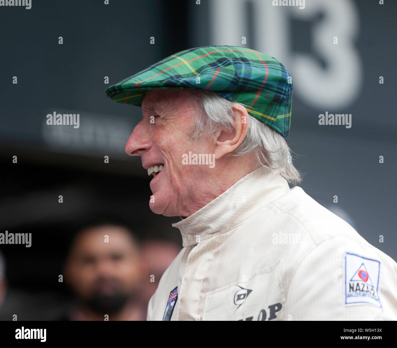 Close-up of a smiling Sir Jackie Stewart, after he had completed several  high-speed laps  around Silverstone in  his 1969 championship-winning Matra MS80-02 Stock Photo